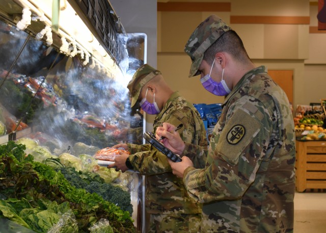 FORT DRUM, N.Y. – Sgt. Dawnavan Wysalde (right), a native of Odessa, Texas, and Sgt. Luis Colon (left), a native of Salinas, Puerto Rico, both veterinary food inspection noncommissioned officers with the Fort Drum Veterinary Treatment Facility, U.S. Army Public Health Activity, check the quality of produce at the commissary on Fort Drum, N.Y. April 24, 2020.  Fort Drum based veterinary food inspection specialists are responsible for ensuring the food on the installation is wholesome and safe for consumption by the Fort Drum community.  (U.S. Army photo by Warren W. Wright Jr., Fort Drum Medical Activity Public Affairs)