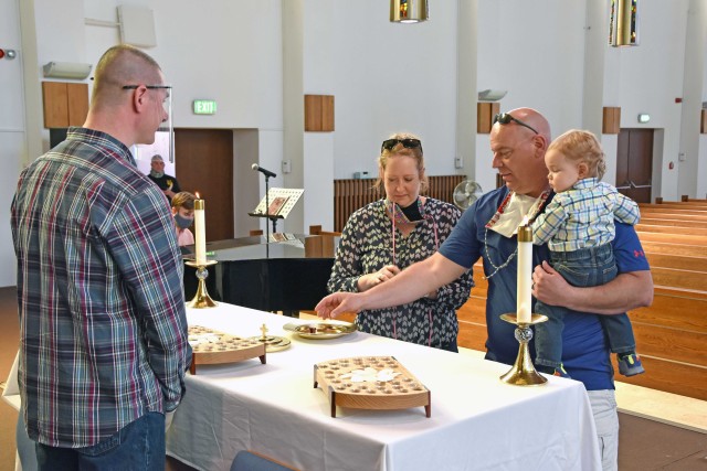 WIESBADEN, Germany - Families and individuals receive the sacrament of communion for the first time in more than 10 weeks May 17 at Hainerberg Chapel. Some physical distancing measures were lifted, allowing the sacrament service to resume while parishioners wore masks, washed their hands and entered the chapel one person or family at a time.