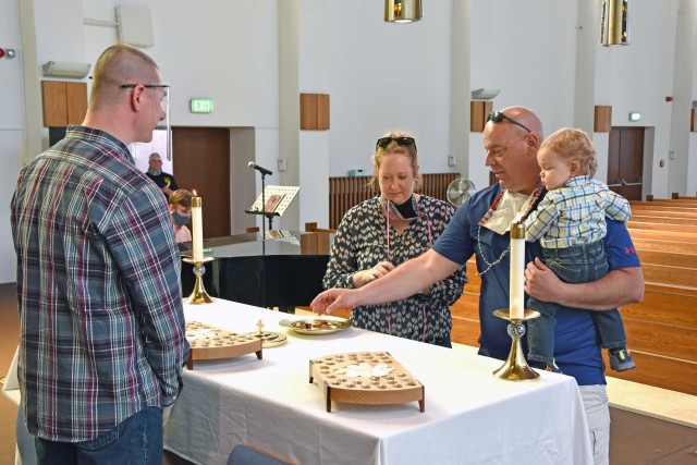 WIESBADEN, Germany - Families and individuals receive the sacrament of communion for the first time in more than 10 weeks May 17 at Hainerberg Chapel. Some physical distancing measures were lifted, allowing the sacrament service to resume while...