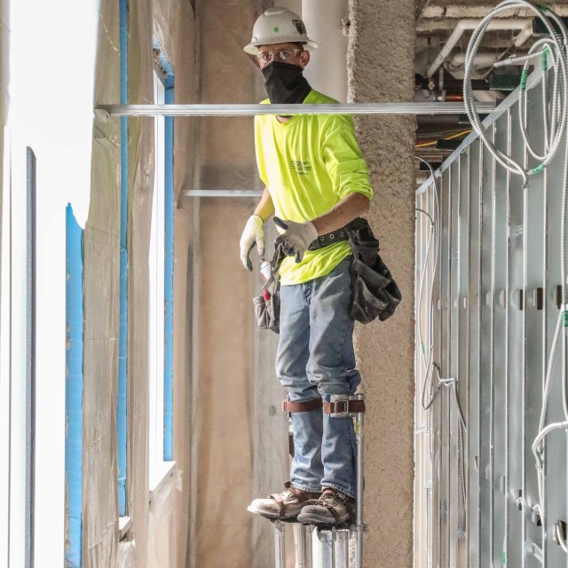 A contractor maneuvers on stilts to install insulation May 14, at what will be an alternate care facility in Kalispell, Mont. The state of Montana requested FEMA to task the U.S. Army Corps of Engineers, Omaha District, to build the ACF on the vacant, undeveloped, third floor of Montana Children’s, the new pediatric facility of the Kalispell Regional Medical Center. The temporary facility would accommodate non-acute patients in case Montana faces an increase in COVID-19 patients in the fall. When completed, the ACF will have 98 patient care rooms, seven nurse’s station, four restrooms, three pharmacies and a medical supply storage room.