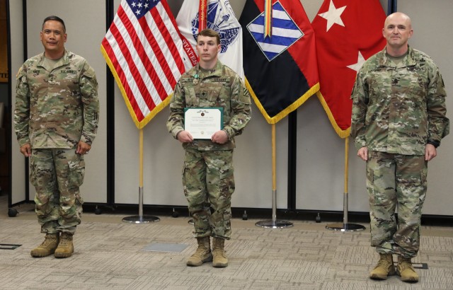Maj. Gen Antonio Aguto left, commander of the 3rd Infantry Division and Command Sgt. Maj. Michael Coffey,  senior enlisted leader, present Spc. Fisher Wall  with an Army Commendation Medal during the award ceremony for the winners of 3rd Infantry...
