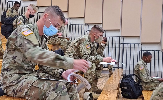 Soldiers fresh out of advanced individual training arriving from Fort Huachuca, Ariz., fill out their in-processing paperwork at the Truscott Air Terminal at Hunter Army Airfield, Ga., May 13, 2020. To maintain the health and safety of incoming...