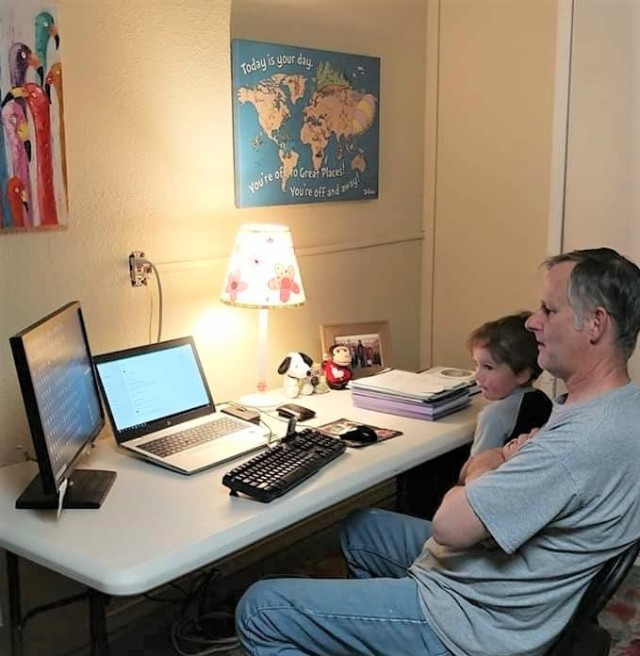 White Sands Missile Range Museum Curator Darren Court receives family support while teleworking at home. 