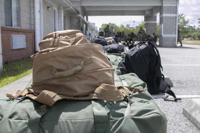 Soldiers arriving by bus from their advanced individual training at Fort Gordon, Ga., stage their bags in front of the Marne Reception Center, Fort Stewart, Ga., May 15, 2020. To maintain the health and safety of incoming personnel and those...