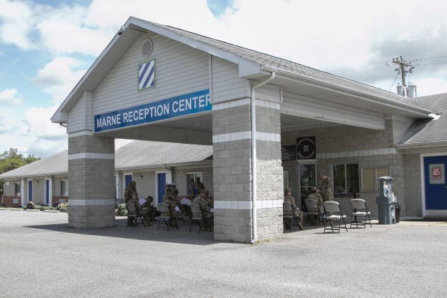 Soldiers arriving by bus from their advanced individual training at Fort Gordon, Ga., assemble at the Marne Reception Center, Fort Stewart, Ga., May 15, 2020, to begin in-processing. To maintain the health and safety of incoming personnel and...