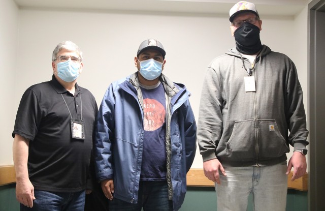 Sal Manteria (left), supervisor for Scott Barracks, Sergio Baquero, Directorate of Public Works custodial head manager for the barracks workforce, and Nate Workmann (right), overtime boss, have led the DPW custodial crew in cleaning the nine barracks buildings since late March. The nine barracks will be inhabited by the cadets when they return in cohorts starting Tuesday.