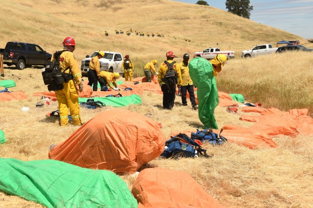 California Guardsmen practice with fire shelters during hand crew training at Camp Roberts on May 14, 2020. 