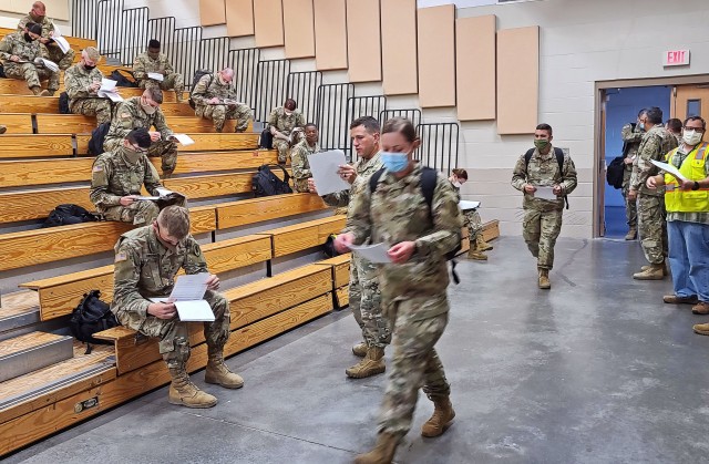 Soldiers fresh out of advanced individual training arriving from Fort Huachuca, Ariz.,fill out their in-processing paperwork at the Truscott Air Terminal at Hunter Army Airfield, Ga., May 13, 2020. To maintain the health and safety of incoming...