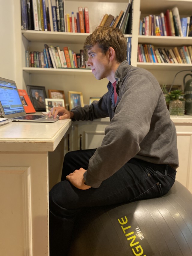 Benjamin Friedlander at telework in his new office, formerly the bedroom of his oldest sister. 