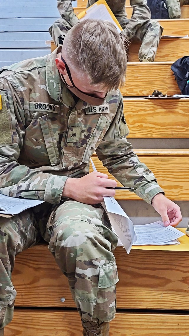 Pvt. Curtis Brooks, an unmanned aircraft systems repairer who is newly assigned to the 3rd Infantry Division, fills out his in-processing paperwork after arriving at the Truscott Air Terminal at Hunter Army Airfield, Ga., May 13, 2020. Brooks just...