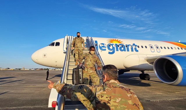 Soldiers fresh out of advanced individual training arriving from Fort Huachuca, Ariz., are guided towards their next in-processing check-point at the Truscott Air Terminal at Hunter Army Airfield, Ga., May 13, 2020. To maintain the health and...