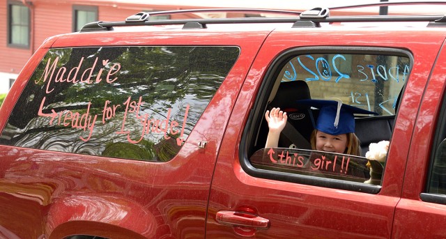 Kindergartner Madeline Brookshire waves as she passes spectators along the graduation parade route May 15 on Grant Avenue. Kindergartners, Patton Junior High School ninth-graders and area high school seniors participated in the parade that honored...