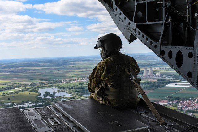 Spc. Justin Cole, B. Co. 1st Bn. 214th Avn. Reg. CH-47 Chinook helicopter crew chief, scans the sky and landscape during the 1-3rd Attack Reconnaissance Battalion (1-3rd ARB) flight exercise May 19. The exercise was an opportunity for the 1-3rd...