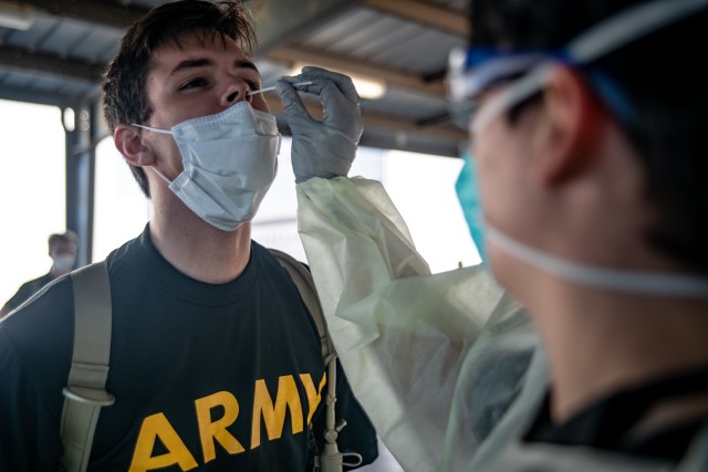 Preparing for Basic Combat Training, a trainee receives a COVID-19 nasal swab test. The check is administered to all trainees whether or not they report symptoms of the infection.