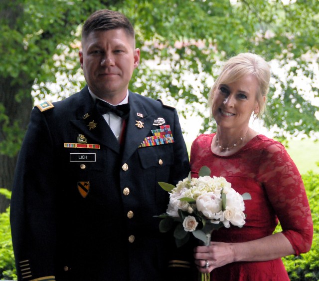 Maj. Theodore Lich and his wife, Shelly, renew their wedding vows on their 10th anniversary  during a ceremony at Quarters One on Rock Island Arsenal, Ill., May 18. Maj. Lich serves as the First Army Division West executive officer.