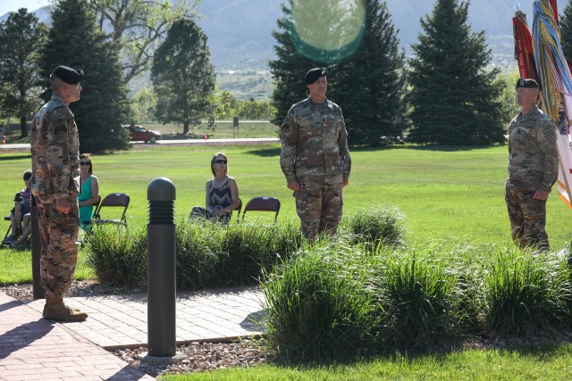 Maj. Gen. Matthew McFarlane, Division Command Sgt. Maj. Adam Nash and Command Sgt. Maj. TJ Holland stand at attention during a change of responsibility ceremony, May 18, 2020, at Manhart Field, Fort Carson. The ceremony hosted a mixture of physical and virtual attendees, with viewers streaming the event through Facebook Live. (U.S. Army photo by Pfc. Kelsey Simmons)