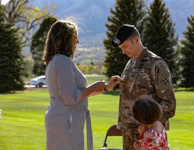 Amy Beaurpere promotes her husband, Brig. Gen. William Beaurpere to brigadier general during his promotion and farewell ceremony May 8, 2020, at Manhart Field at Fort Carson, Colorado. Beaurpere served as the deputy commander of support for the 4th Infantry Division and Fort Carson. (U.S. Army photo by Staff Sgt. Inez Hammon)