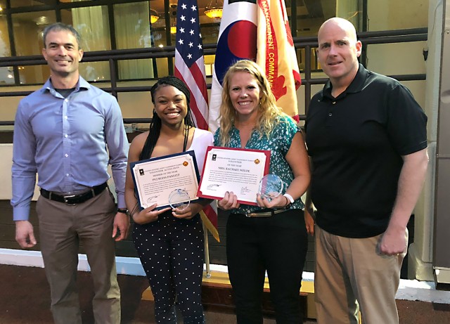 U.S. Army Pfc. Bless Pantlitz, center left, a member of the 563rd Medical Logistics Company, and Rachael Welde, center right, are pictured with USAG-Daegu Commander Col. Ed Ballanco and Command Sgt. Maj. Alan Cline on May 14 at Camp Walker's...