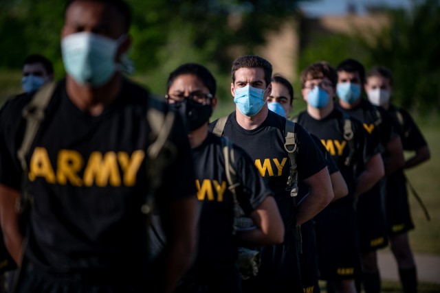 Newly arrived trainees in the 95th Adjutant General Battalion (Reception) stand at parade rest May 14, ready for training while wearing face masks and social distancing to curb the spread of COVID-19.