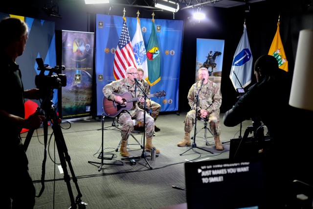 Three members of Rolling Thunder, a rock band formed by musicians with the Maneuver Center of Excellence Band, perform an acoustic concert on Facebook to connect with the community.