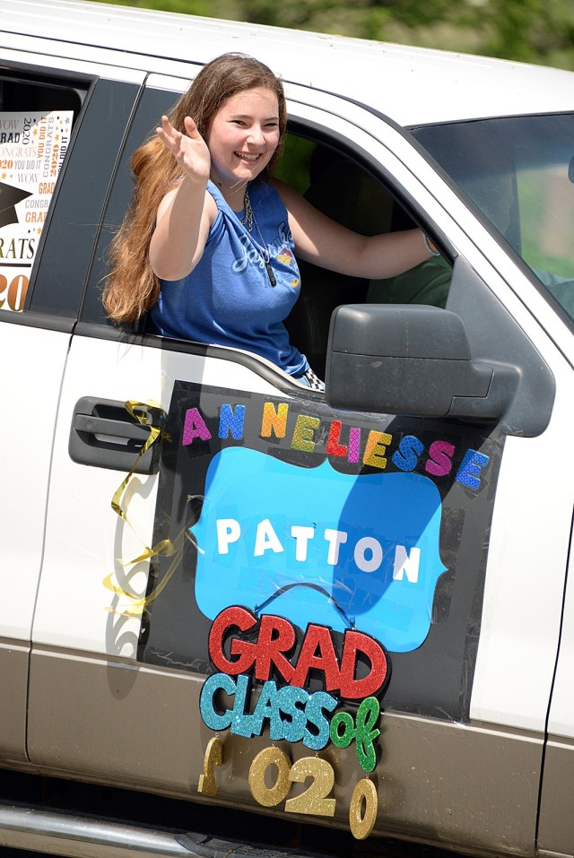 Patton Junior High School ninth-grader Anneliesse Murphy waves to spectators during the graduation parade May 15 on Scott Avenue. Photo by Prudence Siebert/Fort Leavenworth Lamp