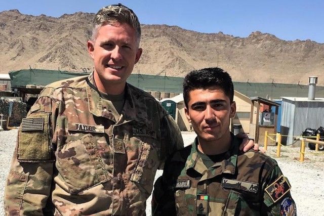 Army Maj. Brent Taylor and an Afghan friend. The young Afghan officer was killed in attacks surrounding Afghanistan's elections in 2018. Three weeks later, the major was killed.