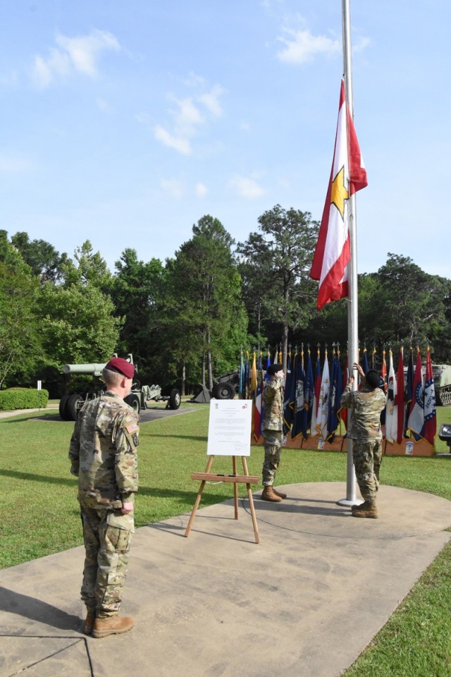 Brig. Gen. Patrick D. Frank, commander, JRTC and Fort Polk, watches as Spc. Joshua D. Cardwell (left) and Sgt. Elvis V. Palarchie, both with Bayne-Jones Army Community Hospital, raise the Gold Star Family Flag at Warrior Memorial Park during a...