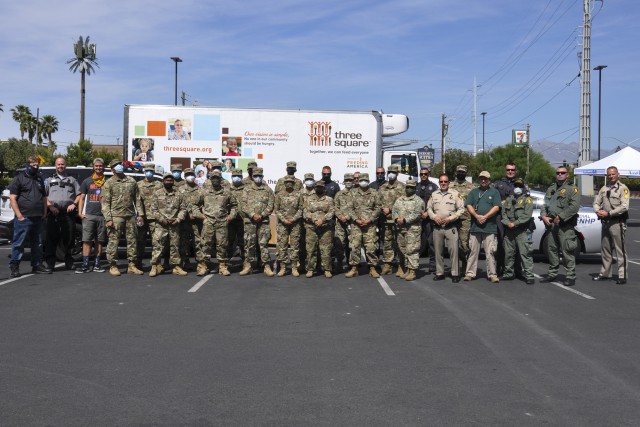 Soldiers with Task Force 221 pose for a picture after food distribution operations with members of the Las Vegas Metropolitan Police Department, Nevada Highway Patrol, Metro React and Three Square, Thursday, May 21, 2020 in Las Vegas, Nevada.