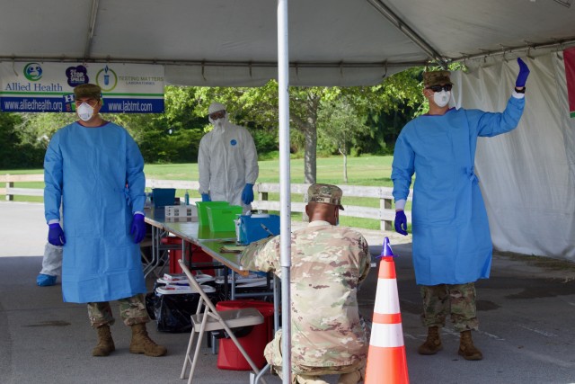 Soldiers from the 144th Transportation Company out of Marianna, Fla. direct traffic at the Amelia Earhart Park CBTS. They have worked at the CBTS as traffic control, scribers, assisting nurses with the test procedure and reporting relevant numbers to the appropriate authorities. (US Army photo by Sgt. Leia Tascarini)