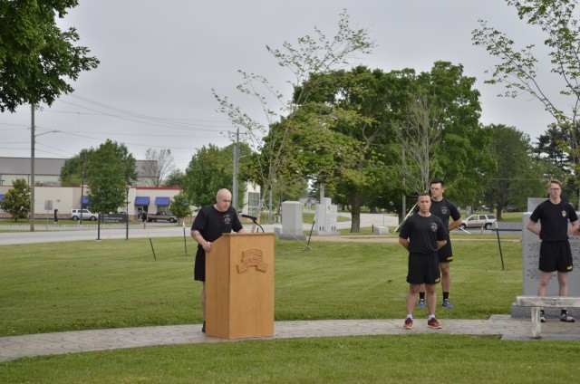 Command Sergeant Major Patrick Doherty, senior enlisted adviser, and Lt. Col. Joseph Da Silva, battalion commander, both of 2nd Battalion, 327th Infantry Regiment, 1st Brigade Combat Team, 101st Airborne Division (Air Assault), reflect on their battalion’s history, May 21, during an opening ceremony for a 24-hour Run for the Fallen at the Bastogne Memorial on Fort Campbell’s Memorial Row.