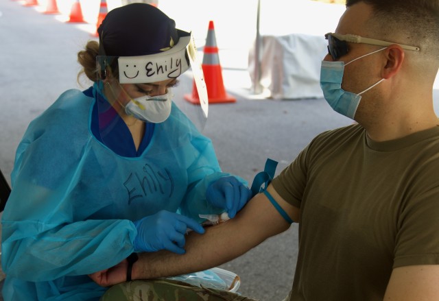 Florida National Guard Soldier Staff Sgt. Trinity Bierley has blood drawn for the COVID-19 antibody test at the Miami Beach Convention Center Community Based Testing Site in South Florida. The Florida Guard is providing support at the Miami Beach hybrid CBTS and Hard Rock Stadium CBTS to allow the state and local partners to conduct antibody testing for first responders at both facilities. (US Army photo by Sgt. Leia Tascarini)