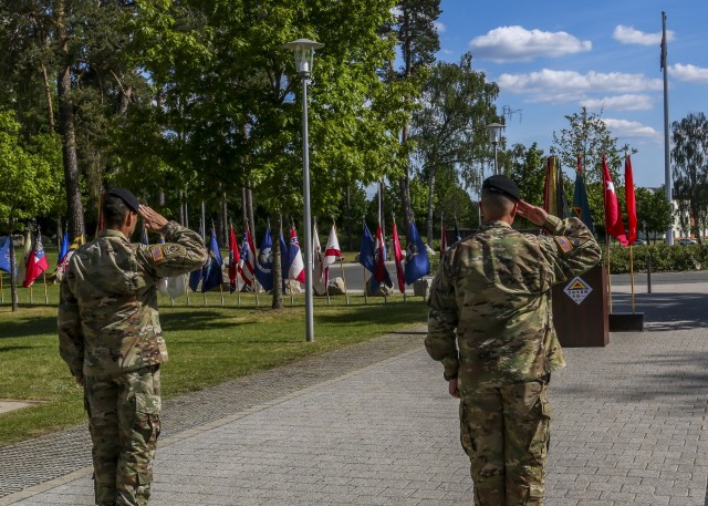 Brig. Gen. Christopher Norrie, commanding general, 7th Army Training Command, and Command Sgt. Maj. Franklin Velez, senior enlisted advisor, 7th ATC salute the flag during the start of the Service with Honor ceremony in Grafenwoehr, Germany May 21, 2020. The Service with Honor ceremony, hosted by Norrie, was held to recognize senior leaders for their hard work and dedication while assigned to 7th ATC. (U.S. Army photo by Spc. Zack Stahlberg)