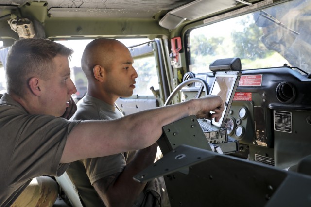 U.S. Army Pvt. Brent Dehollander and Spc. Marcos Martinez both of 6-9 Cavalry Regiment, 3rd Armored Brigade Combat Team, 1st Cavalry Division, work together to diagnose a problem on a High Mobility Medium-Wheeled Vehicle at Rodriguez Live Fire...