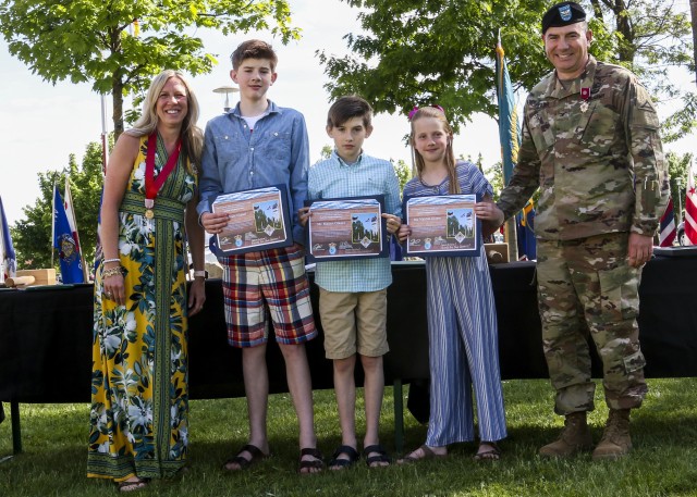 Col. William Glaser, chief of staff, 7th Army Training Command, poses for a picture with his wife and three kids after presenting his children with the Certificate of Appreciation for Little Ambassadors during the Service with Honor ceremony in Grafenwoehr, Germany, May 21, 2020. The Service with Honor ceremony, hosted by Brig. Gen. Christopher Norrie, commanding general, 7th ATC, was held to recognize senior leaders for their hard work and dedication while assigned to 7th ATC. (U.S. Army photo by Spc. Zack Stahlberg)