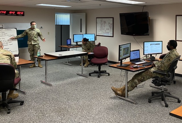 Maj. Paul Wolfe conducts training on the Logistics Civil Augmentation Program with members of the 611th Contracting Team’s Staff Sgt. Marilyn Tangonan and Sgt. 1st Class Daryl Slate May 13 at Fort Stewart, Georgia, as part of a unit contingency contracting exercise in preparation for the team’s deployment.