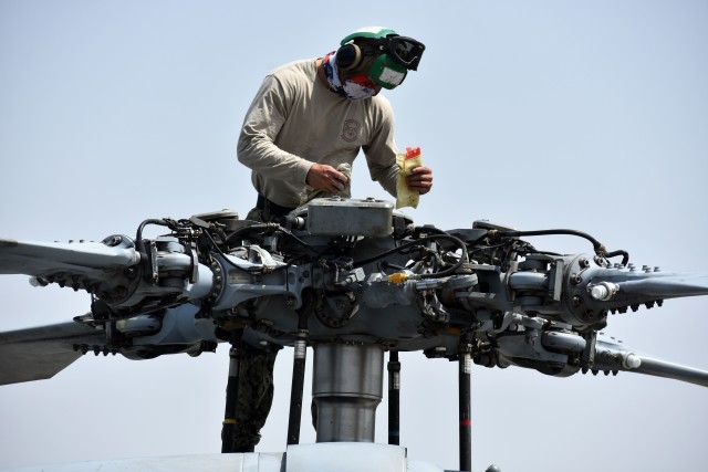 Navy Petty Officer 2nd Class Abrahanjakou Gudino Boscan, assigned to the Helicopter Sea Combat Squadron 25, Detachment 6, the “Archangels,” works on a Navy MH-60S Sea Hawk helicopter at Kastner Army Heliport, Camp Zama, Japan, May 13.