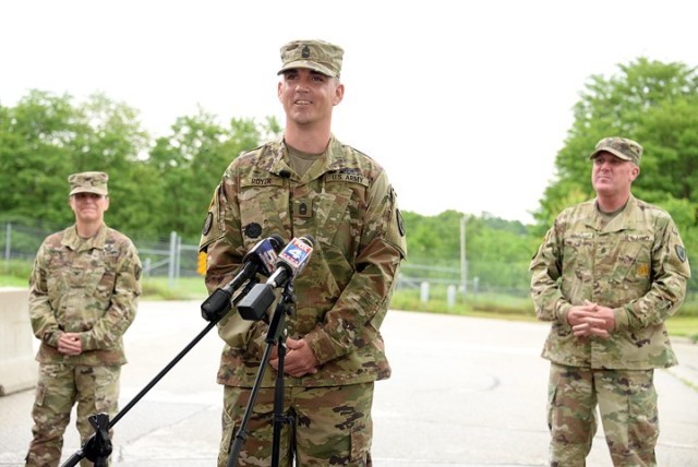 Master Sgt. David Royer, 705th Military Police Battalion (Detention), supported by 15th MP Brigade Commander Col. Caroline Smith and 705th MP Battalion Command Sgt. Maj. Justin Shad, speaks to area reporters about taking action to subdue an active shooter the day before on Centennial Bridge in Leavenworth during a press conference May 28 at Sherman Gate. 