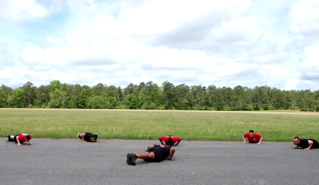 Sgt. Martin Fane, 46th Engineer Battalion, does push ups with his squad. Pictured, from left to right: Pfc. Preston Brown, Pfc. Quinton Smith, Spc. Ronald Jones, Pvt. Joel Hensley and Pvt. Don Govero. Fane is in the center of the formation.
