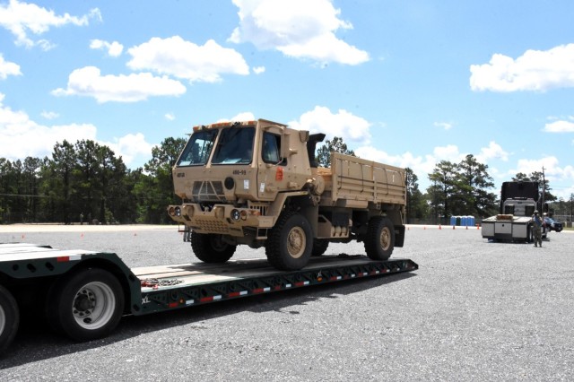 Soldiers for 4th SFAB  retrieve a vehicle from the centralized receiving and shipping point on Fort Polk.