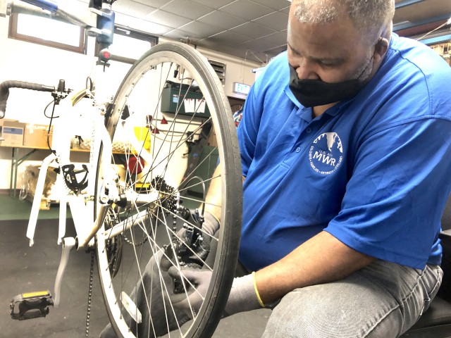 Sam Stinson, USAG Rheinland-Pfalz Outdoor Recreation maintenance supervisor, puts a new chain on a customer's bicycle. USAG RP Outdoor Recreation is now open for rentals and customer bicycle tune-ups. Trips are expected to be available soon.