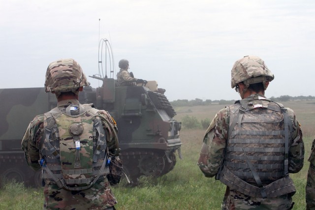 13 Mike MOS students watch an M270A1 go by after a fires mission May 6, 2020, at Fort Sill&#39;s East Range. Observing the fires mission was part of their cumulative training exercise.