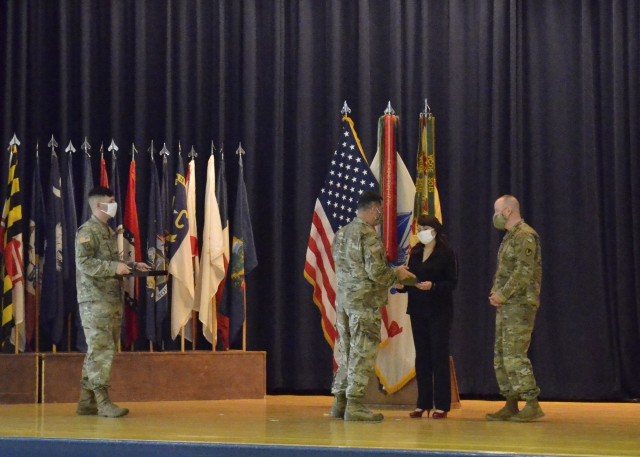 For her service to the installation Donna Osborne, wife of Command Sgt. Maj. Jason W. Osborne, outgoing U.S. Army Garrison-Fort Campbell senior enlisted adviser, was awarded a Meritorious Public Service Medal and a bouquet of red roses, May 28, during her husband’s change of responsibility ceremony at Wilson Theater, Fort Campbell. 