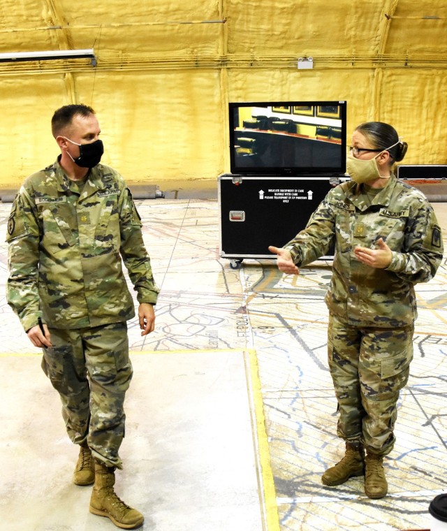 Maj. Sarah Jones, JRTC SOC (left), converses with Maj. Edwin Bodenheim, 4th SFAB executive officer.