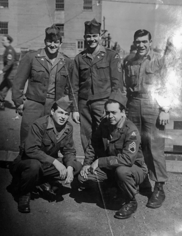 Mike Rauseo, top right, a Soldier and heavy truck driver with the 1st Armored Divison, poses with other Soldiers and members of 1AD during World War II. Rauseo served with 1AD in Tunisia and Italy, participating in the Battle of Monte Cassino as well as competing with and coaching numerous 1AD athletic teams. (Courtesy photo)