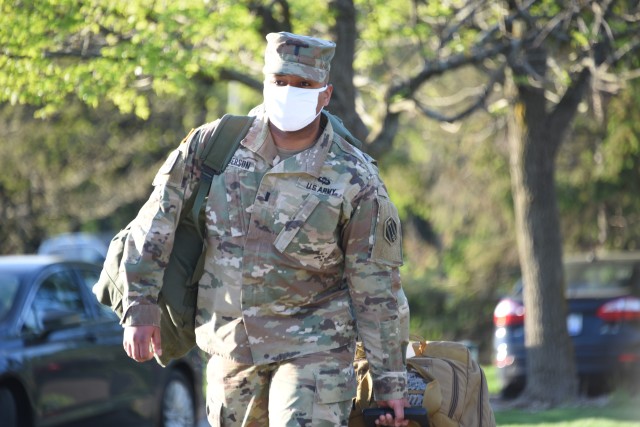 Packed and ready to go, 1st Lt. Alonzo Roberson-Dawkins carries his equipment to be loaded for travel as Task Force 46 executes its Deployment Readiness Exercise, May 21, 2020, in Lansing, Michigan.  Task Force 46 is the headquarters for the...