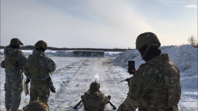 Soldiers from 1st Stryker Brigade Combat Team, 25th Infantry Division fire small arm rounds on a barrier to evaluate the effectiveness of constructing protective HESCO barriers using snow, water and cellulose. After firing, the team deconstructed...