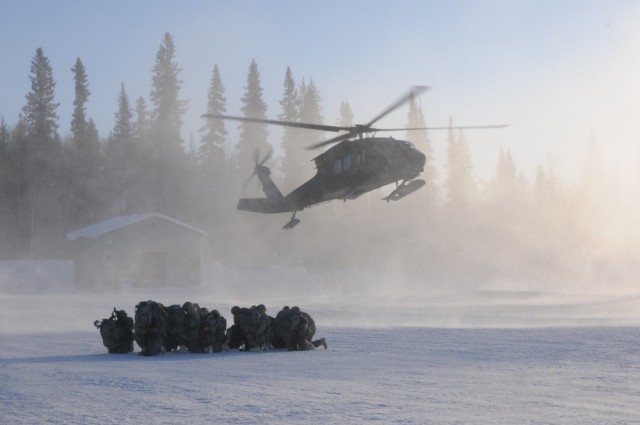 Members of 1st Battalion, 297th Infantry Regiment based in Fairbanks, Alaska and part of the Alaska National Guard, prepare to board a UH-60 Black Hawk Helicopter operated by members of 1st Battalion, 169th Aviation Regiment of the New Hampshire...