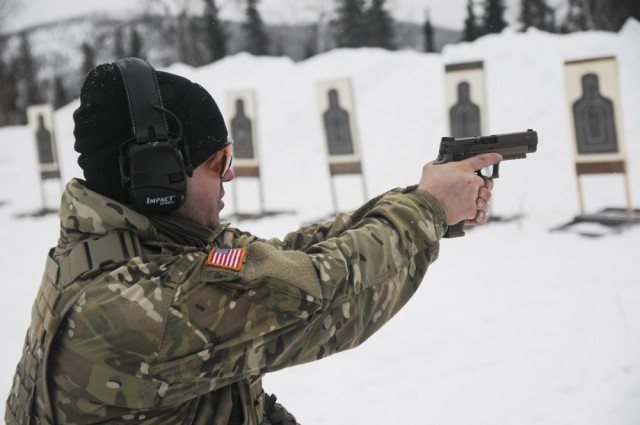 Staff Sgt. Sean E. Davis, a member of 1st Battalion, 297th Infantry Regiment, based in Joint Base Elmendorf-Richardson, Alaska, tests out the new SIG Sauer M17 Army service pistol March 1, in the Yukon Training Area on Eielson Air Force Base as...