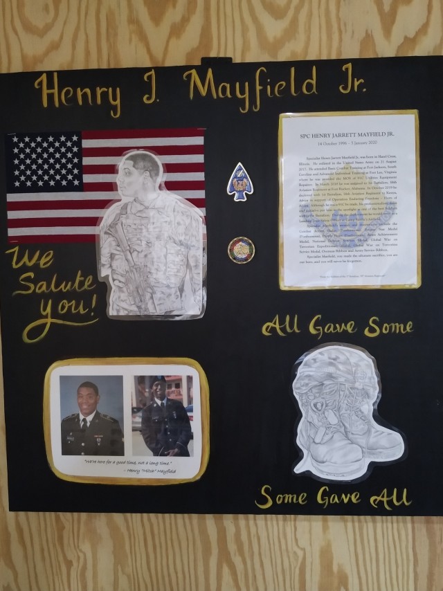 A memorial for U.S. Army Spc. Henry “Mitch” Mayfield, Jr. sits inside the Henry Mayfield Jr. Dining Facility at Baledogle Military Airfield (BMA), Somalia, May 1, 2020. The Henry Mayfield Jr. Dining Facility includes a hand-drawn portrait, as well as information about Mayfield’s military career. The facility, which had its grand opening and dedication ceremony May 1, was named in honor of Mayfield, who was killed in action Jan. 5, 2020, during an attack on Manda Bay Airfield, Kenya, by a terrorist organization. Mayfield, a Chicago native, was deployed to Kenya with the 1st Battalion, 58th Aviation Regiment, 164th Theater Airfield Operations Group, from Fort Rucker, Alabama. (U.S. Navy photo by Logistics Specialist 2nd Class Toniece Lurch)