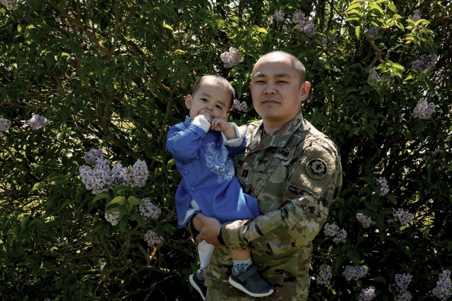 U.S. Army Capt. Vinh T. Nguyen, military police officer, assigned to the 2d Cavalry Regiment, poses with son after discussing significant aspects of  Vietnamese culture in honor of Asian American and Pacific Islander Heritage Month in Vilseck,...